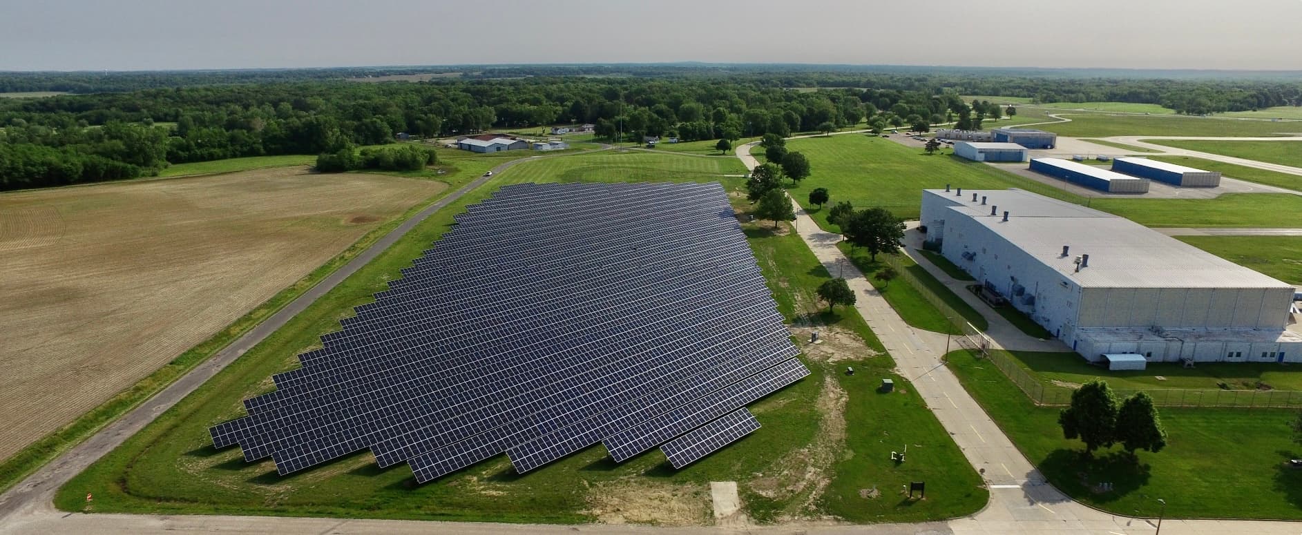 Aerial view of a solar installation surrounded by green space